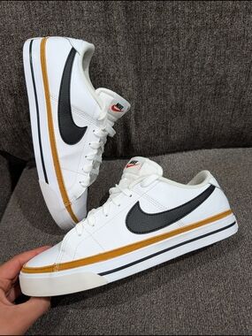 Nike Women’s White Sneakers with Black Swoosh and Gold Accent